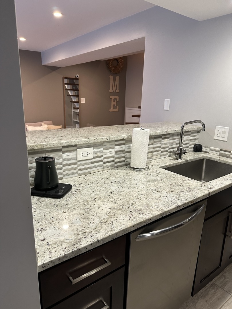 9830 Sayre Avenue, Unit 13 Chicago Ridge, IL 60415 - Photo 11 of 34 a kitchen with kitchen island granite countertop a sink and a stove