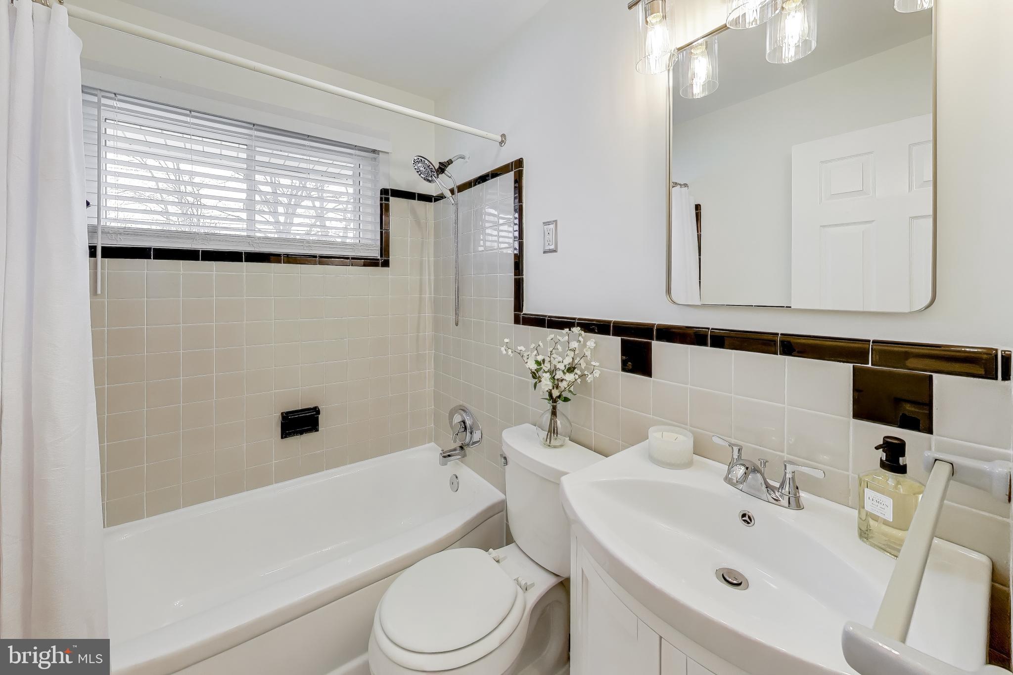 7402 Inzer Street Springfield, VA 22151 - Photo 21 of 49 a bathroom with a sink a toilet and shower