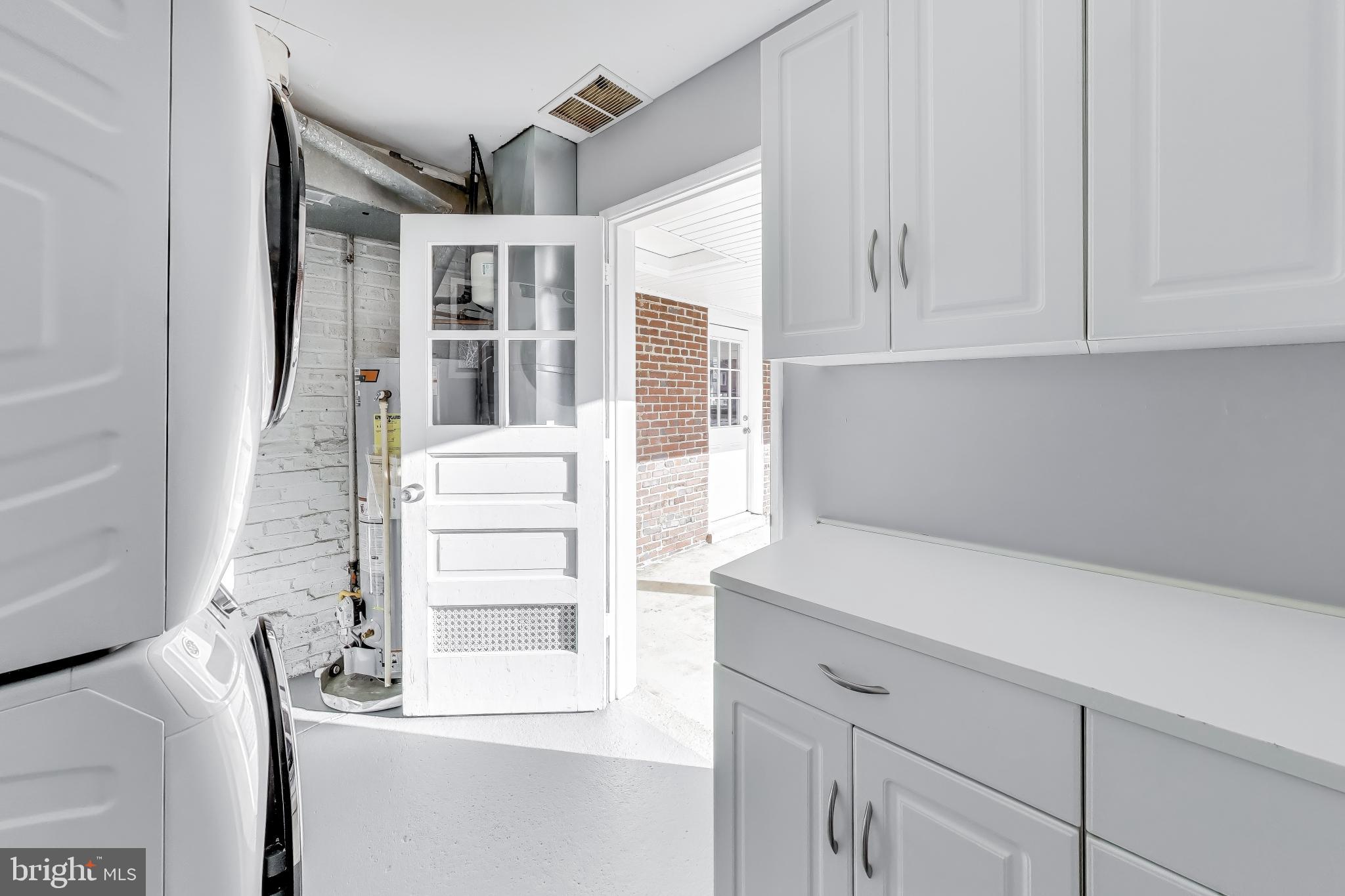 7402 Inzer Street Springfield, VA 22151 - Photo 22 of 49 a kitchen with a white cabinets and a stove
