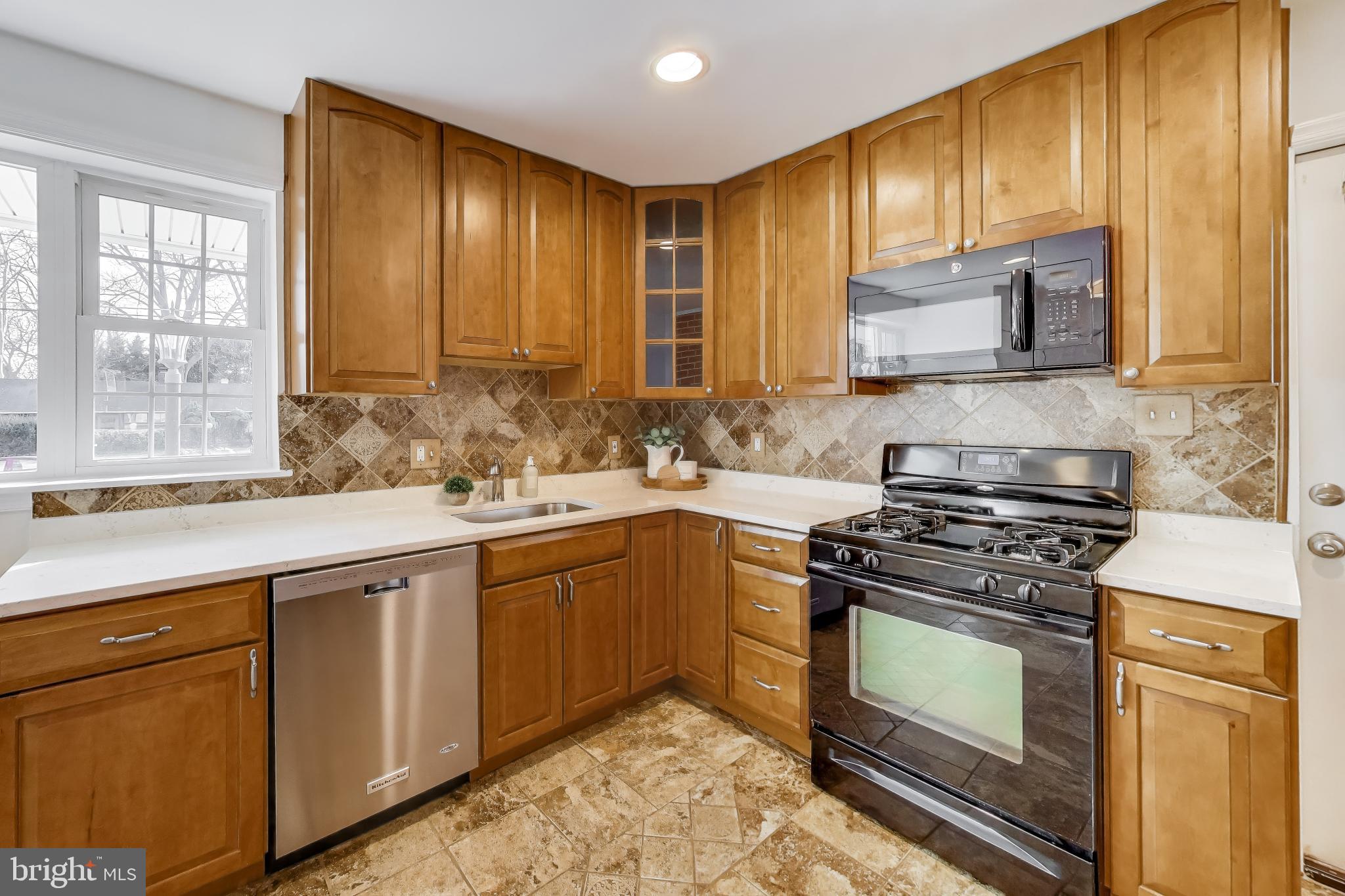 7402 Inzer Street Springfield, VA 22151 - Photo 5 of 49 a kitchen with stainless steel appliances granite countertop wooden cabinets sink and stove top oven