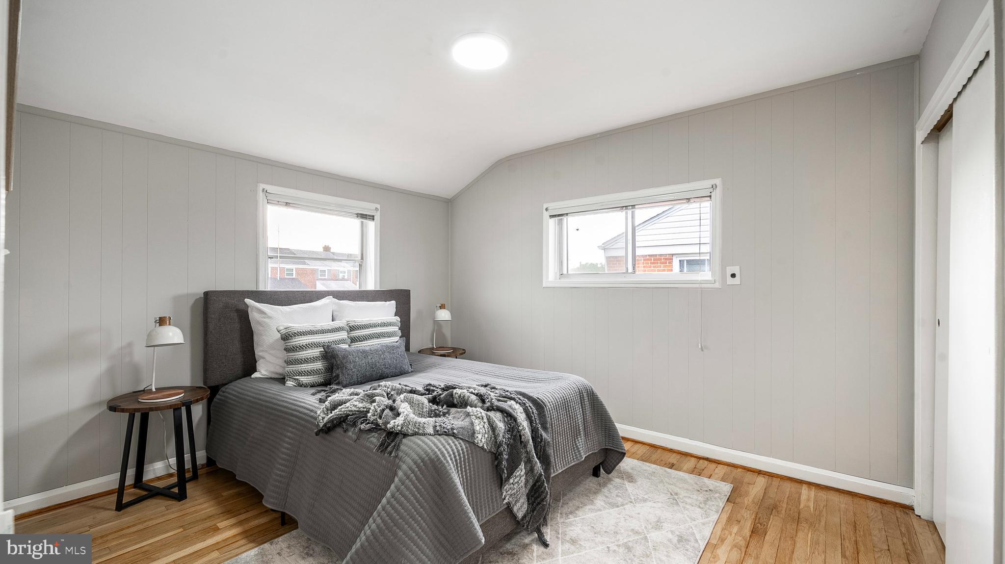 7913 Charlesmont Road Baltimore, MD 21222 - Photo 12 of 27 a bedroom with a bed and wooden floor