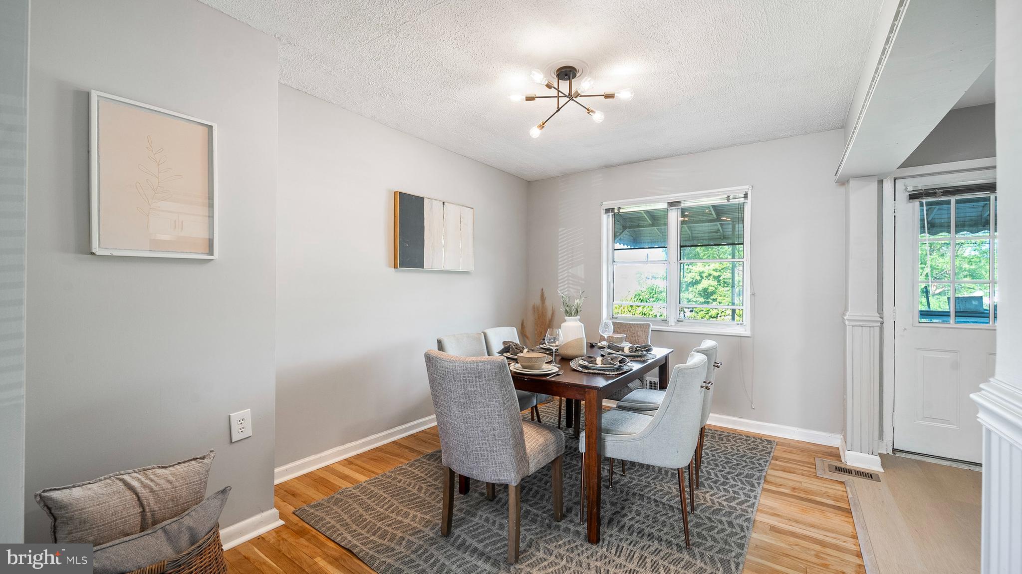 7913 Charlesmont Road Baltimore, MD 21222 - Photo 8 of 27 a view of a dining room with furniture and wooden floor