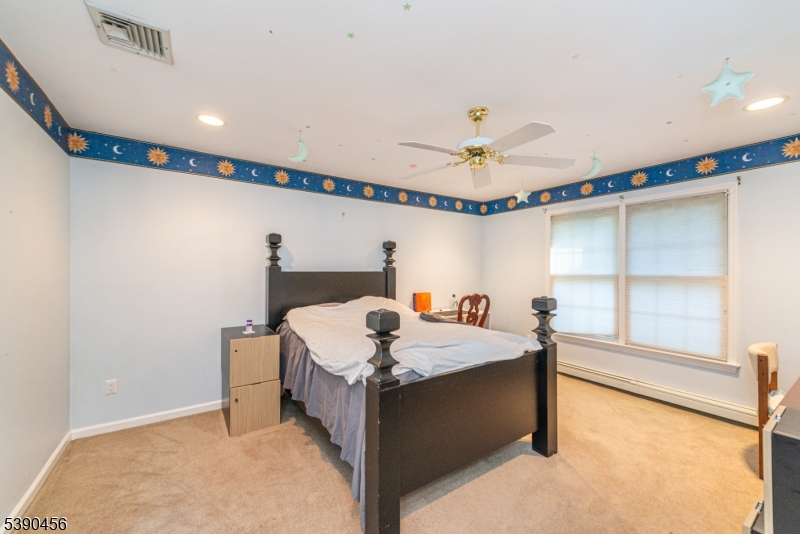 190 Andover Mohawk Road Andover, NJ 07821 - Photo 14 of 46 a bedroom with a bed and a chandelier