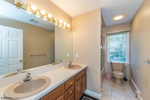 a bathroom with a sink double vanity and a toilet