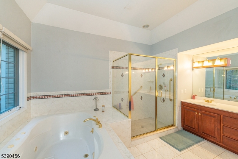 190 Andover Mohawk Road Andover, NJ 07821 - Photo 23 of 46 a spacious bathroom with a tub shower sink and mirror