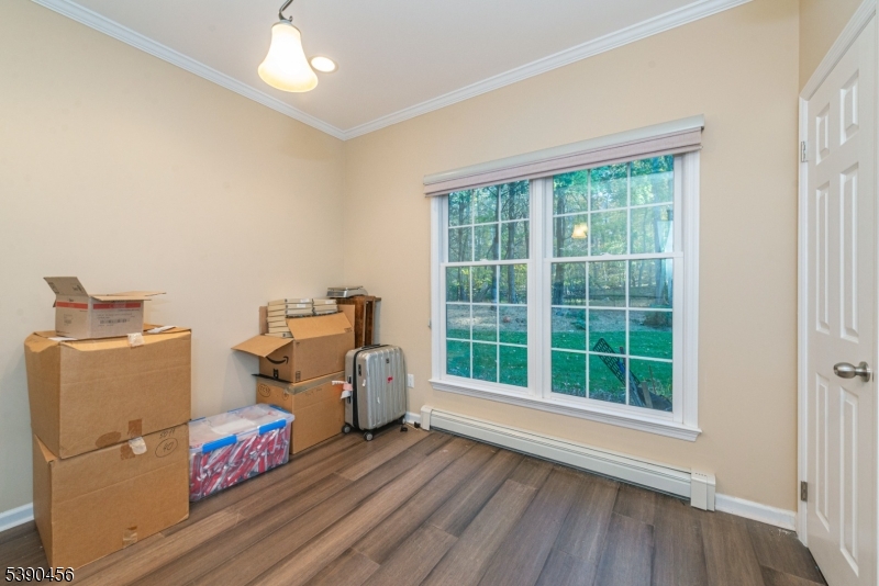 190 Andover Mohawk Road Andover, NJ 07821 - Photo 24 of 46 an empty room with wooden floor and windows