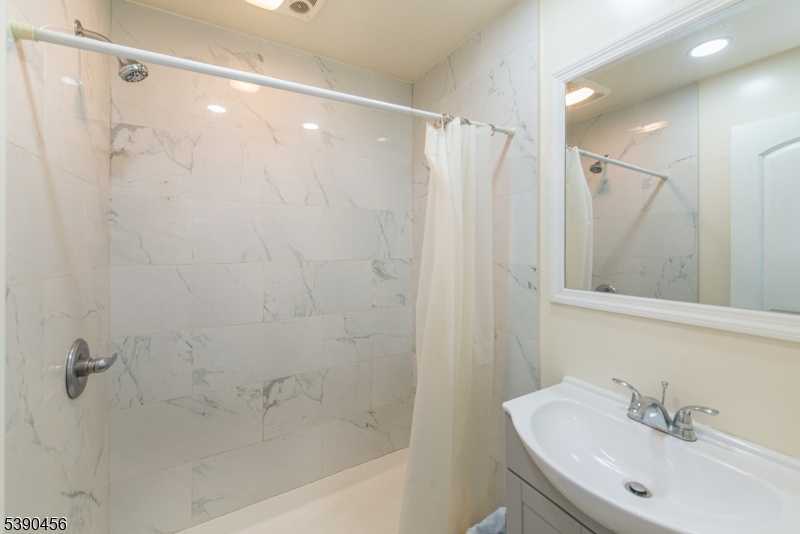 190 Andover Mohawk Road Andover, NJ 07821 - Photo 34 of 46 a bathroom with a shower curtain and a sink