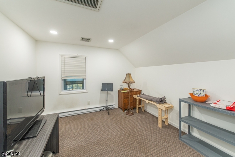 190 Andover Mohawk Road Andover, NJ 07821 - Photo 39 of 46 a room with furniture and a flat screen tv