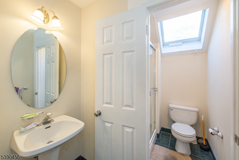 190 Andover Mohawk Road Andover, NJ 07821 - Photo 40 of 46 a bathroom with a toilet sink and mirror