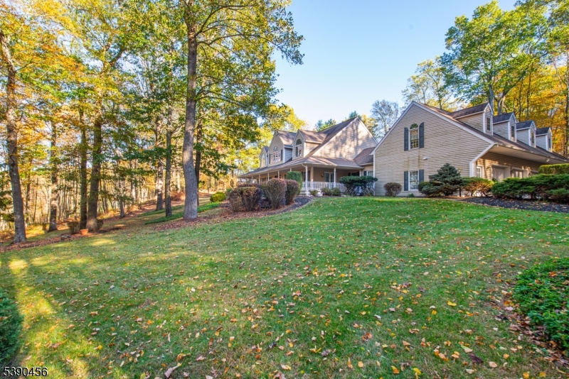 190 Andover Mohawk Road Andover, NJ 07821 - Photo 4 of 46 a front view of a house with a yard and trees
