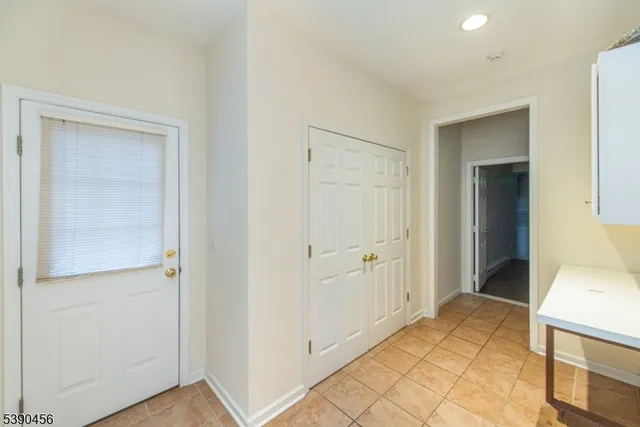 a view of a hallway to rooms