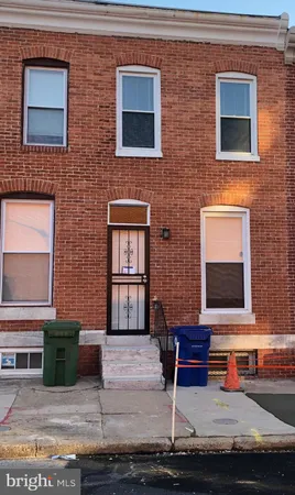 a brick house with a bench in front of it