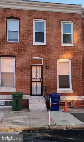 a brick house with a bench in front of it
