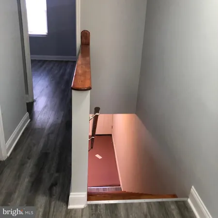 a view of hallway with wooden floor