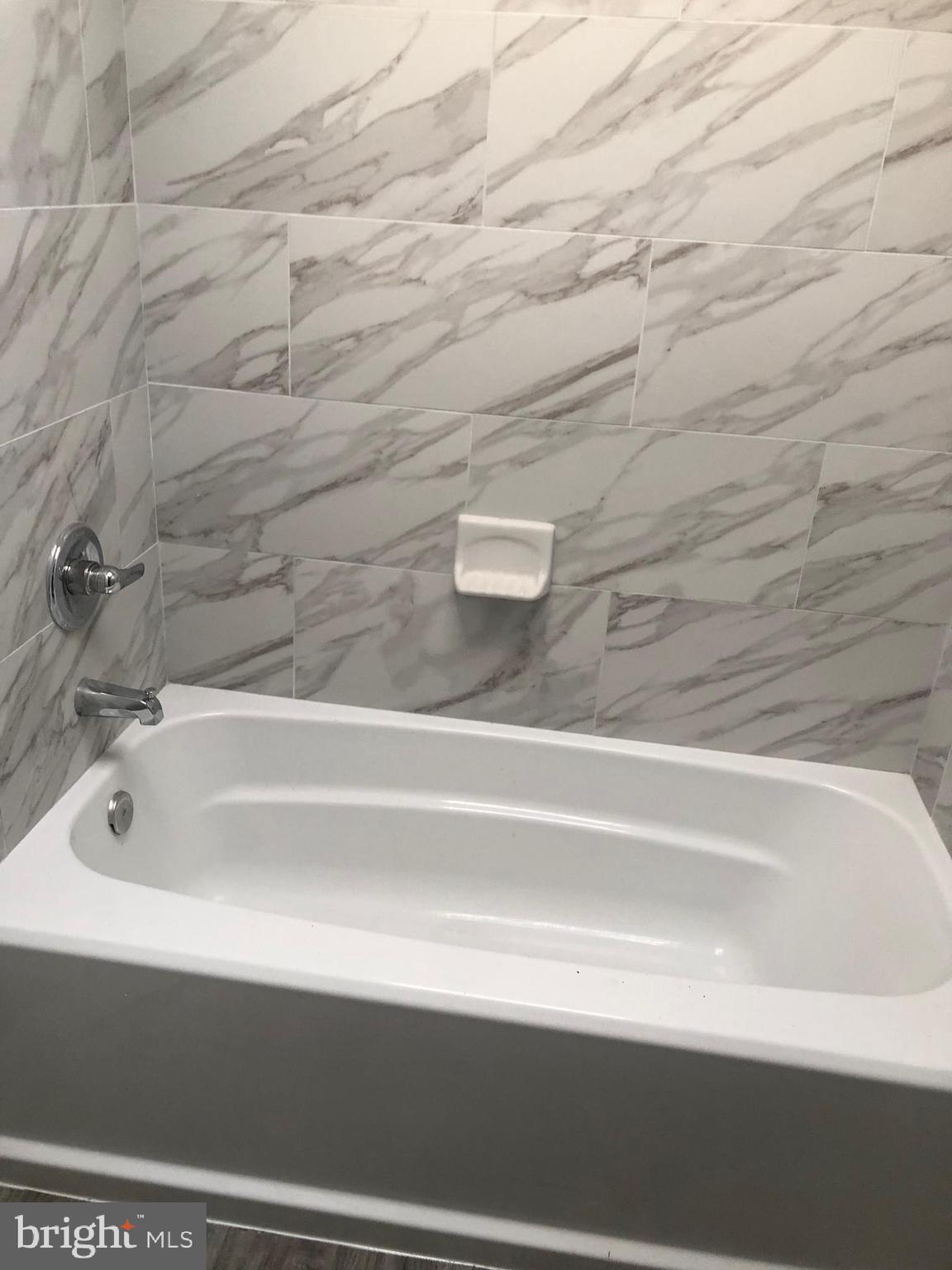 2123 East Chase Street Baltimore, MD 21213 - Photo 16 of 21 a bathroom with a bathtub