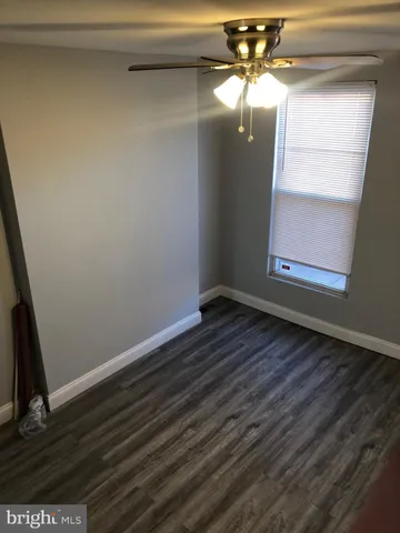 a view of a small space with wooden floor and a cabinet
