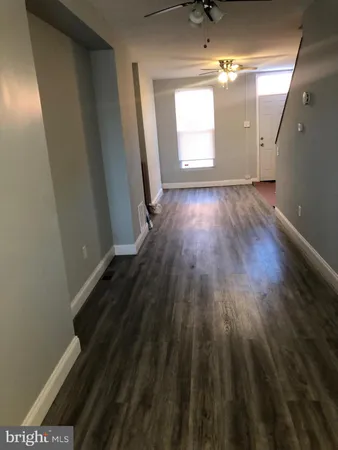 a view of a room with wooden floor and windows