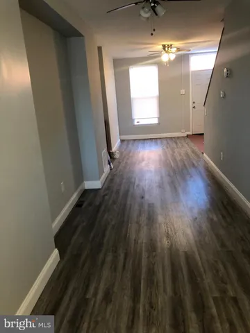 a view of a room with wooden floor and windows