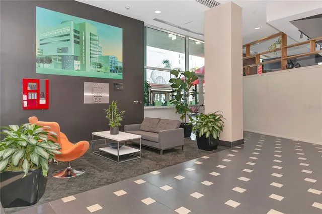 a lobby with furniture and potted plants