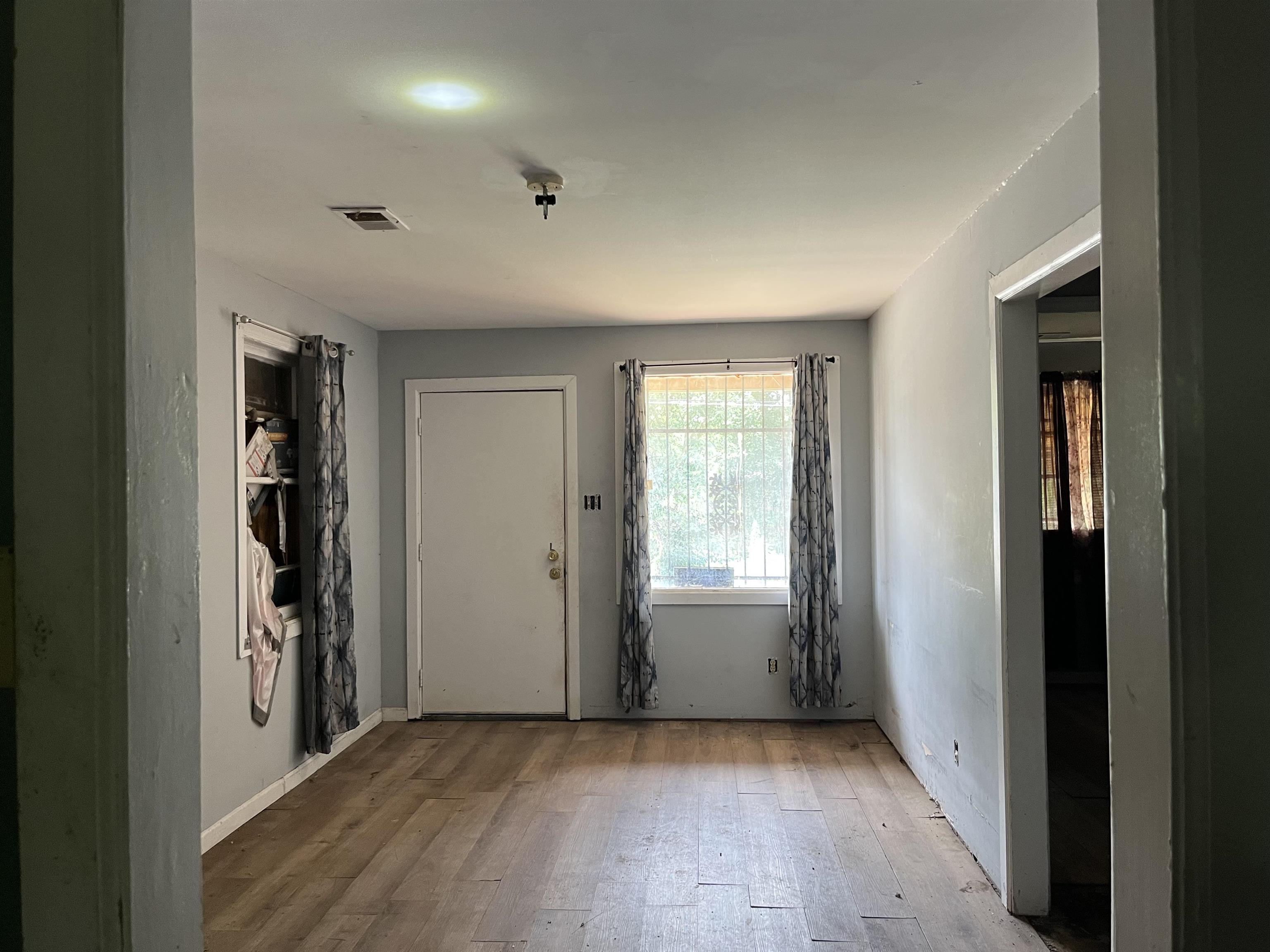 100 Silverage Avenue Memphis, TN 38109 - Photo 8 of 30 Interior space featuring wood-finish flooring, light gray wall paint, and white trim