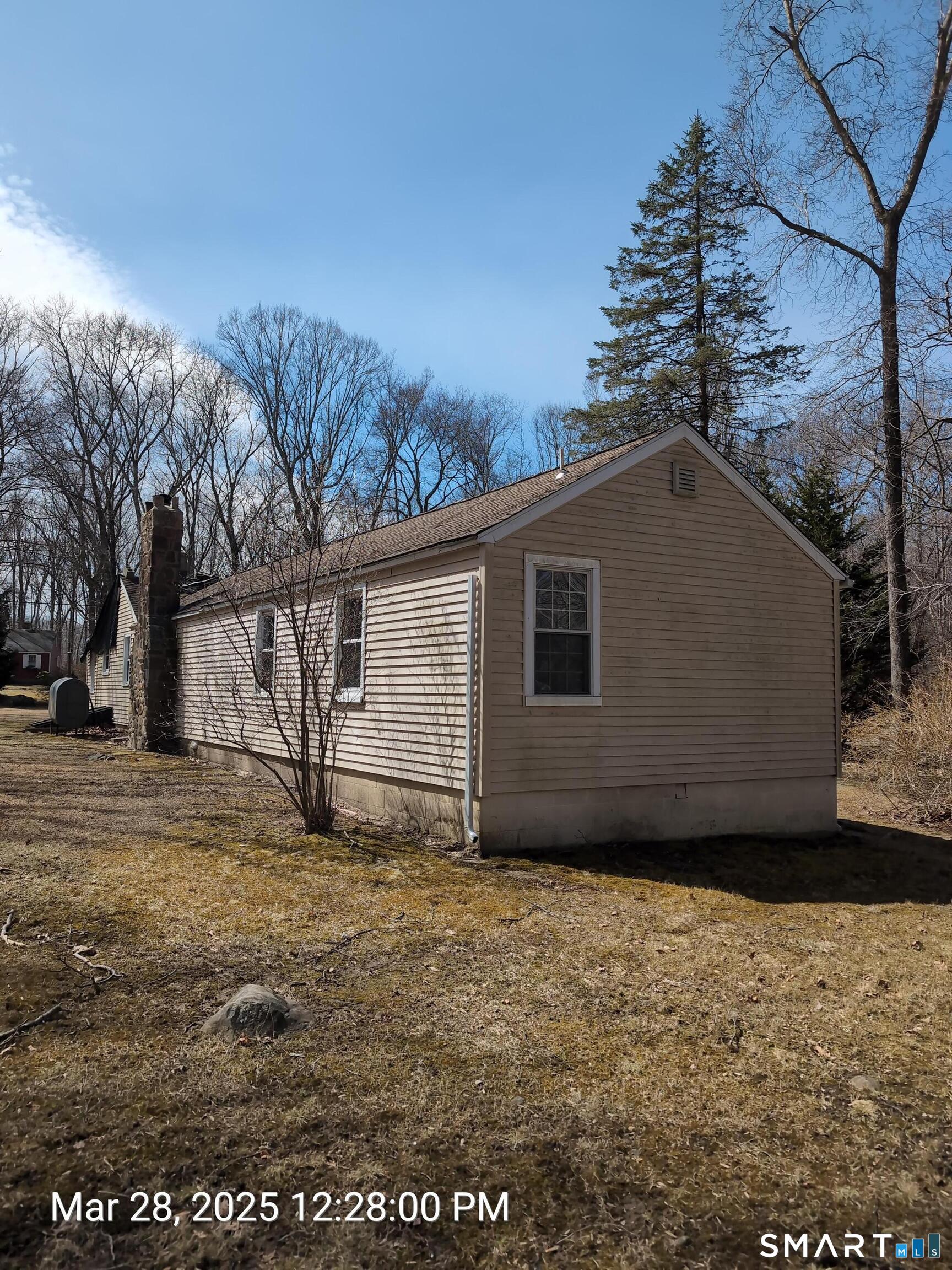 97 Bushy Hill Road Deep River, CT 06417 - Photo 6 of 28 a house with trees in the background