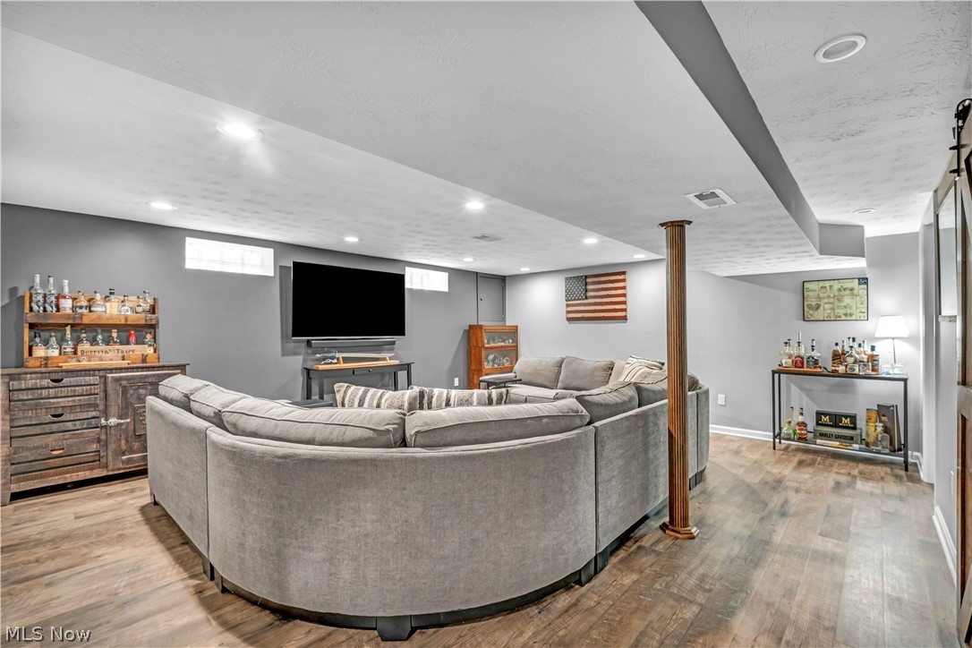 977 Lloyd Road Wickliffe, OH 44092 - Photo 22 of 38 In-law/guest suite with recessed lighting, wood-finish flooring, exposed support column, and wall-mounted television