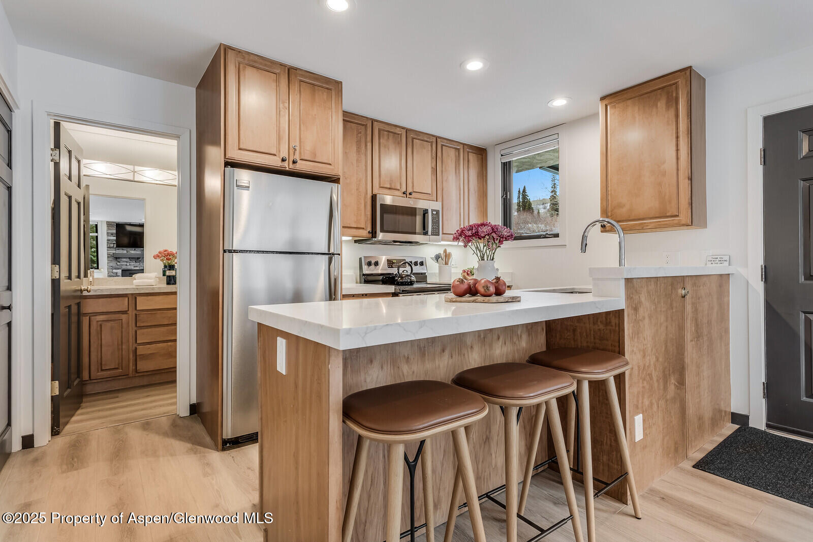 135 Carriage Way, Unit 5 Snowmass Village, CO 81615 - Photo 14 of 59 a kitchen with stainless steel appliances a stove refrigerator and cabinets