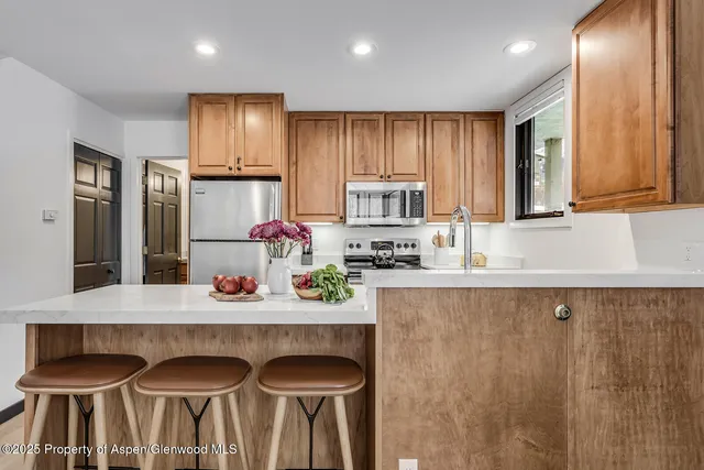 a kitchen with granite countertop a sink and white cabinets