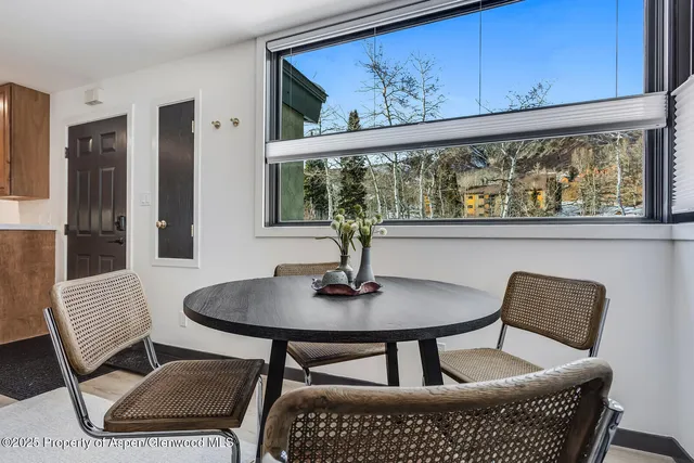 a dining room with furniture and window