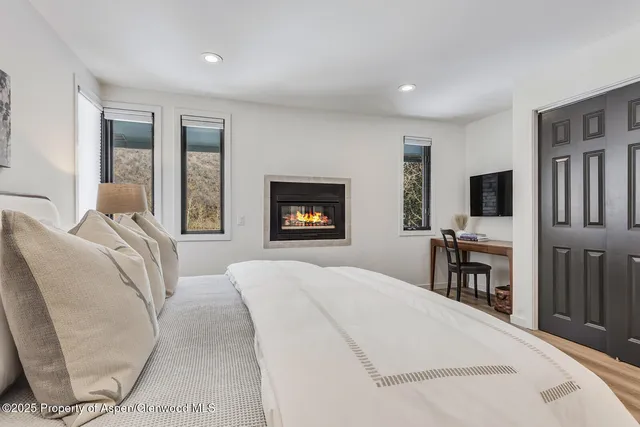 a bedroom with furniture and a window