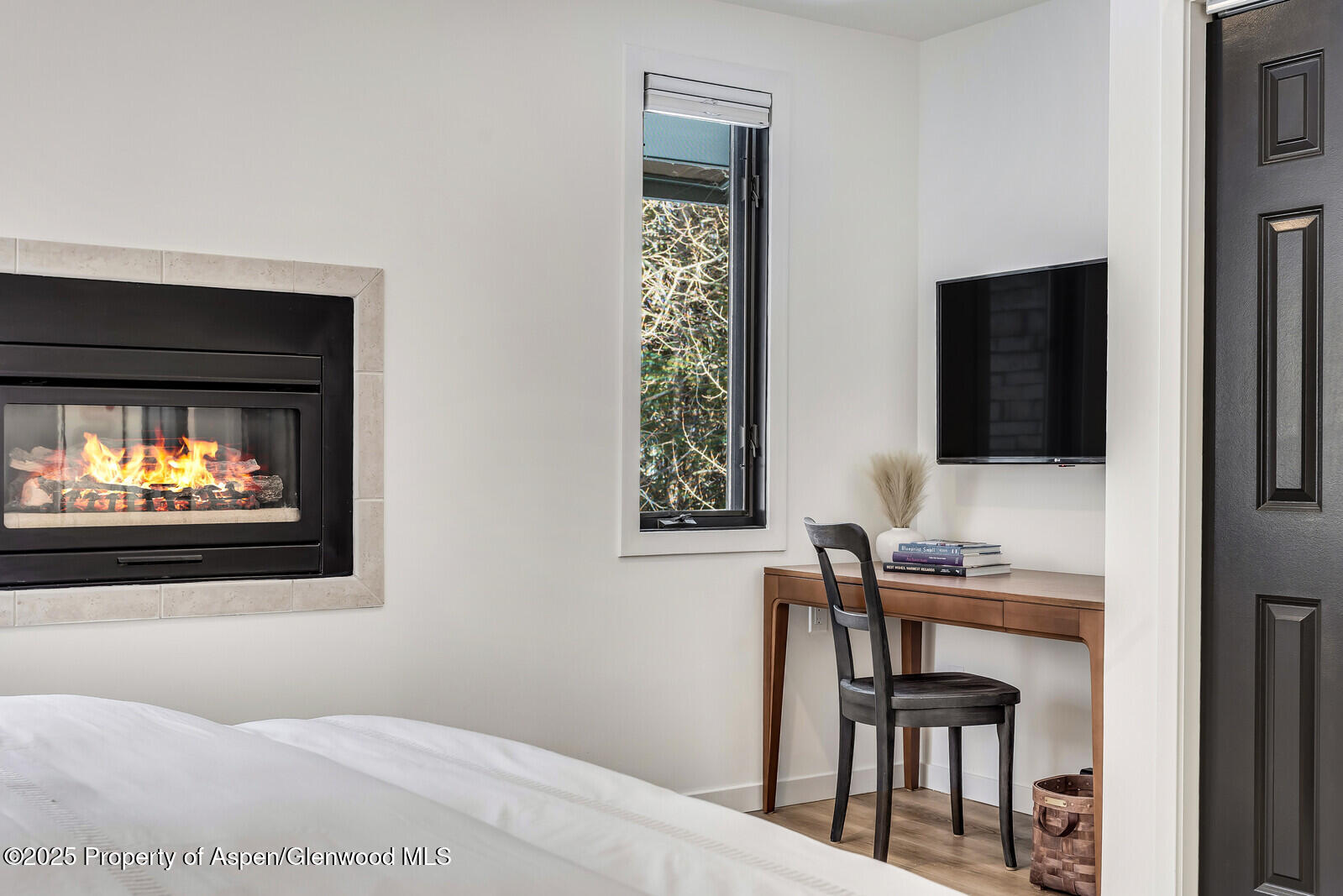 135 Carriage Way, Unit 5 Snowmass Village, CO 81615 - Photo 30 of 59 a bedroom with a bed and a flat screen tv