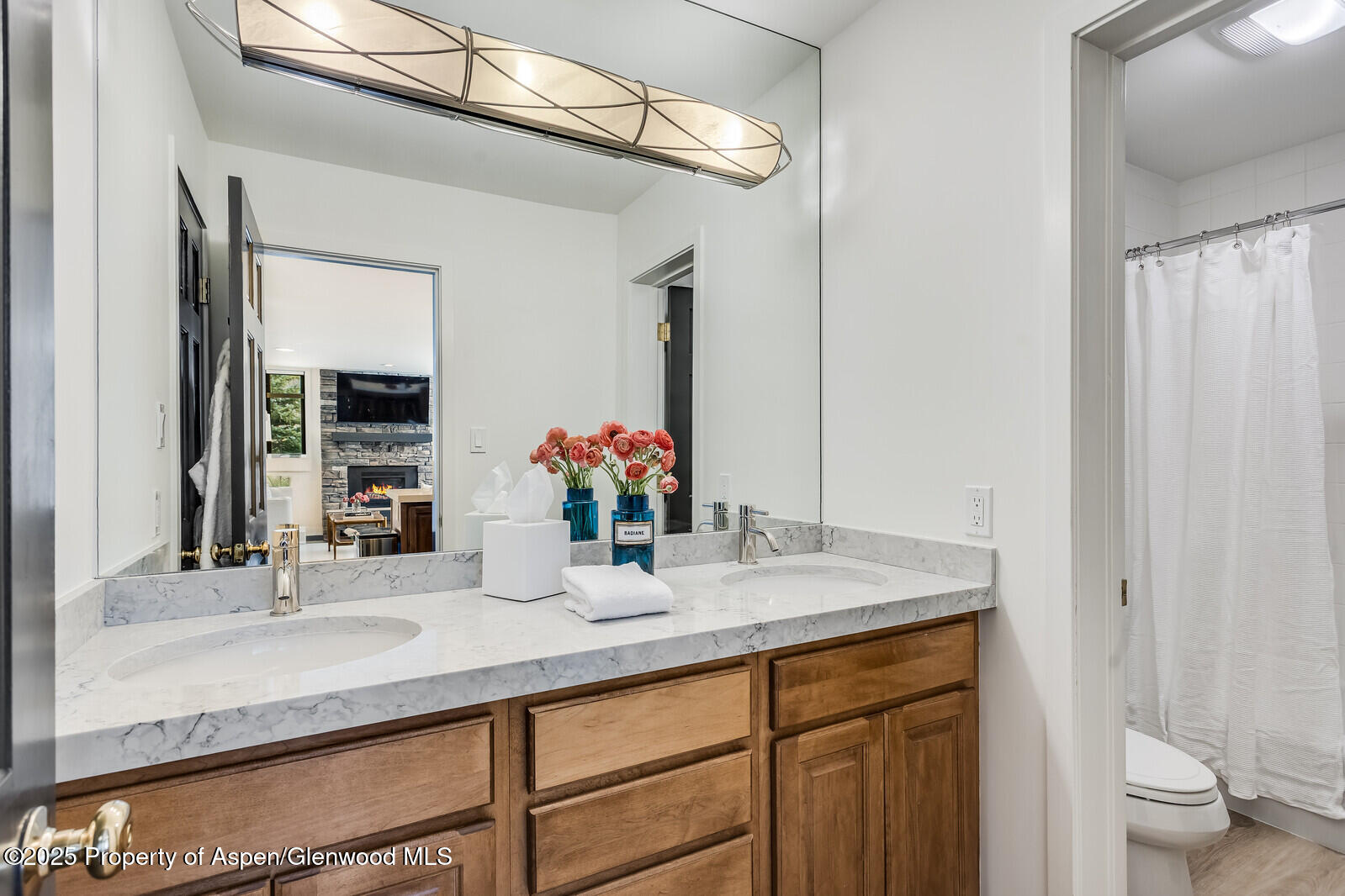 135 Carriage Way, Unit 5 Snowmass Village, CO 81615 - Photo 35 of 59 a bathroom with a sink and a mirror