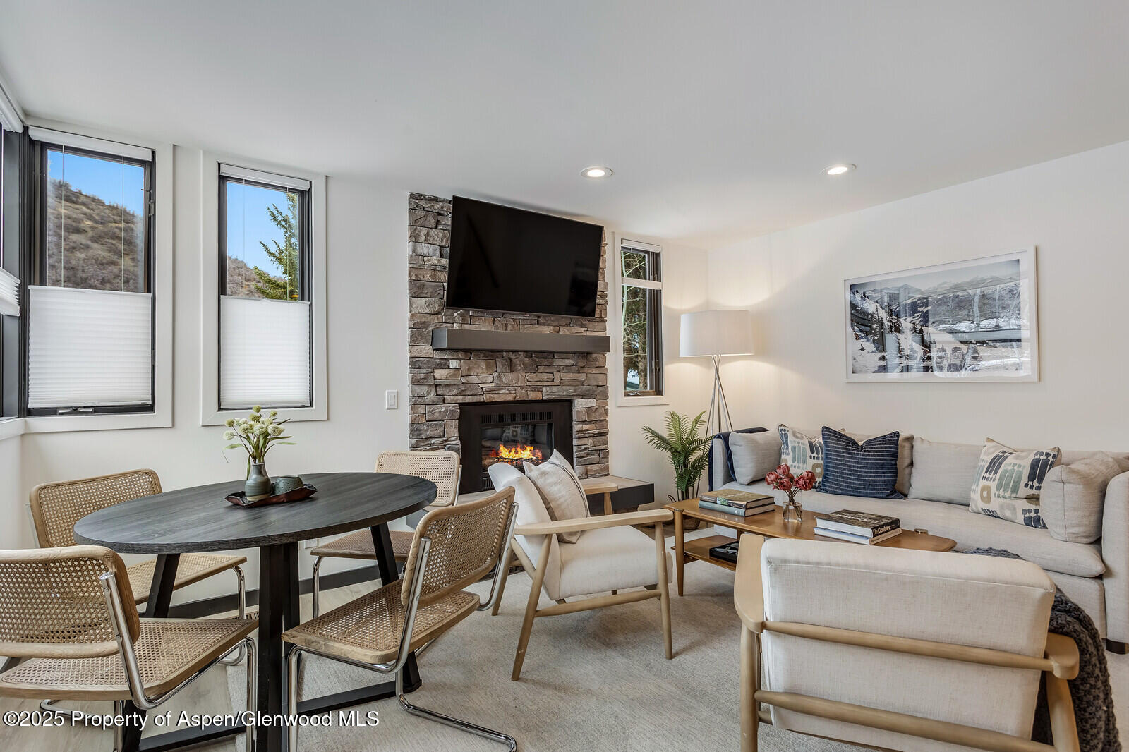 135 Carriage Way, Unit 5 Snowmass Village, CO 81615 - Photo 4 of 59 a living room with furniture a flat screen tv and a fireplace