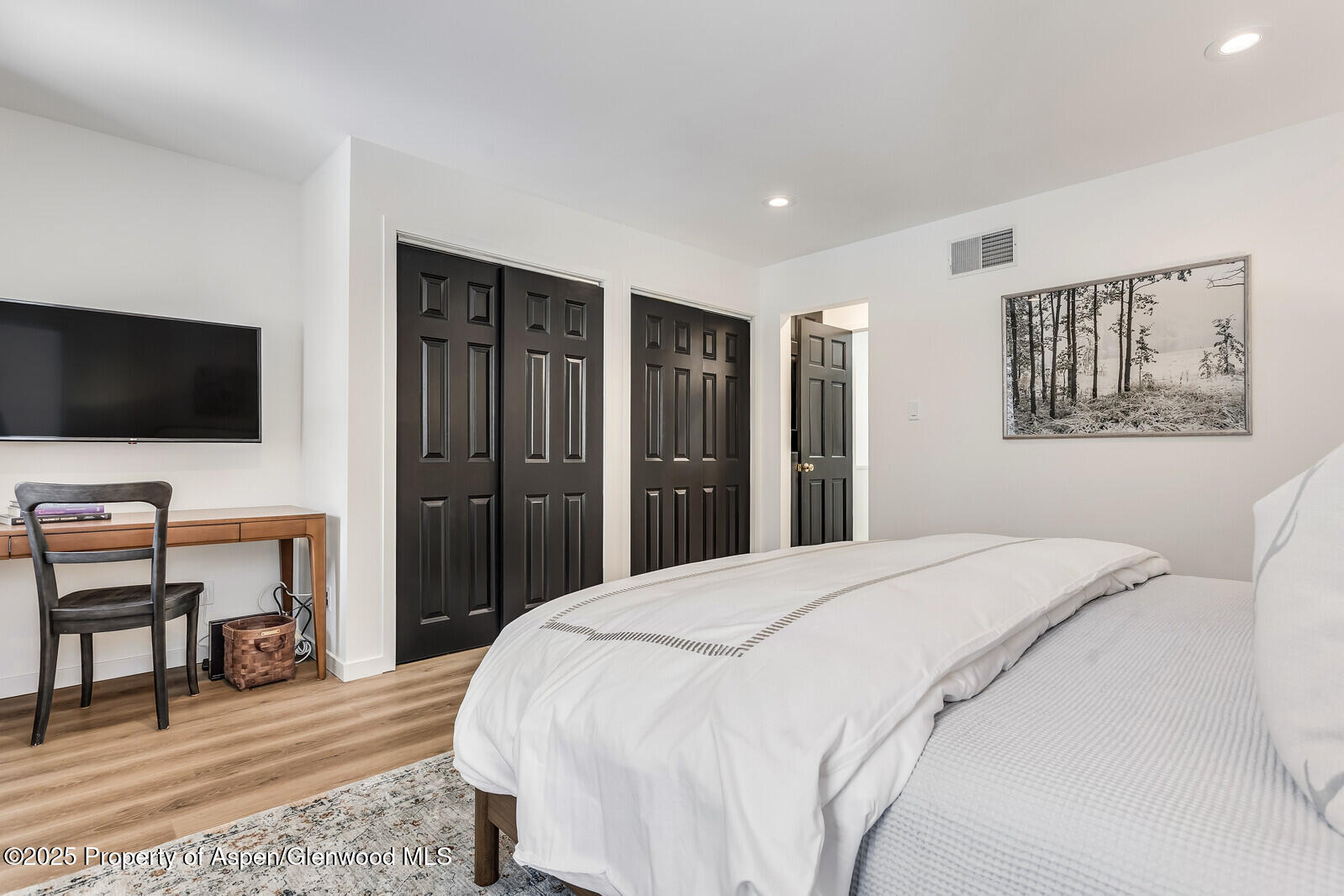 135 Carriage Way, Unit 5 Snowmass Village, CO 81615 - Photo 42 of 59 a spacious bedroom with a bed and a flat screen tv