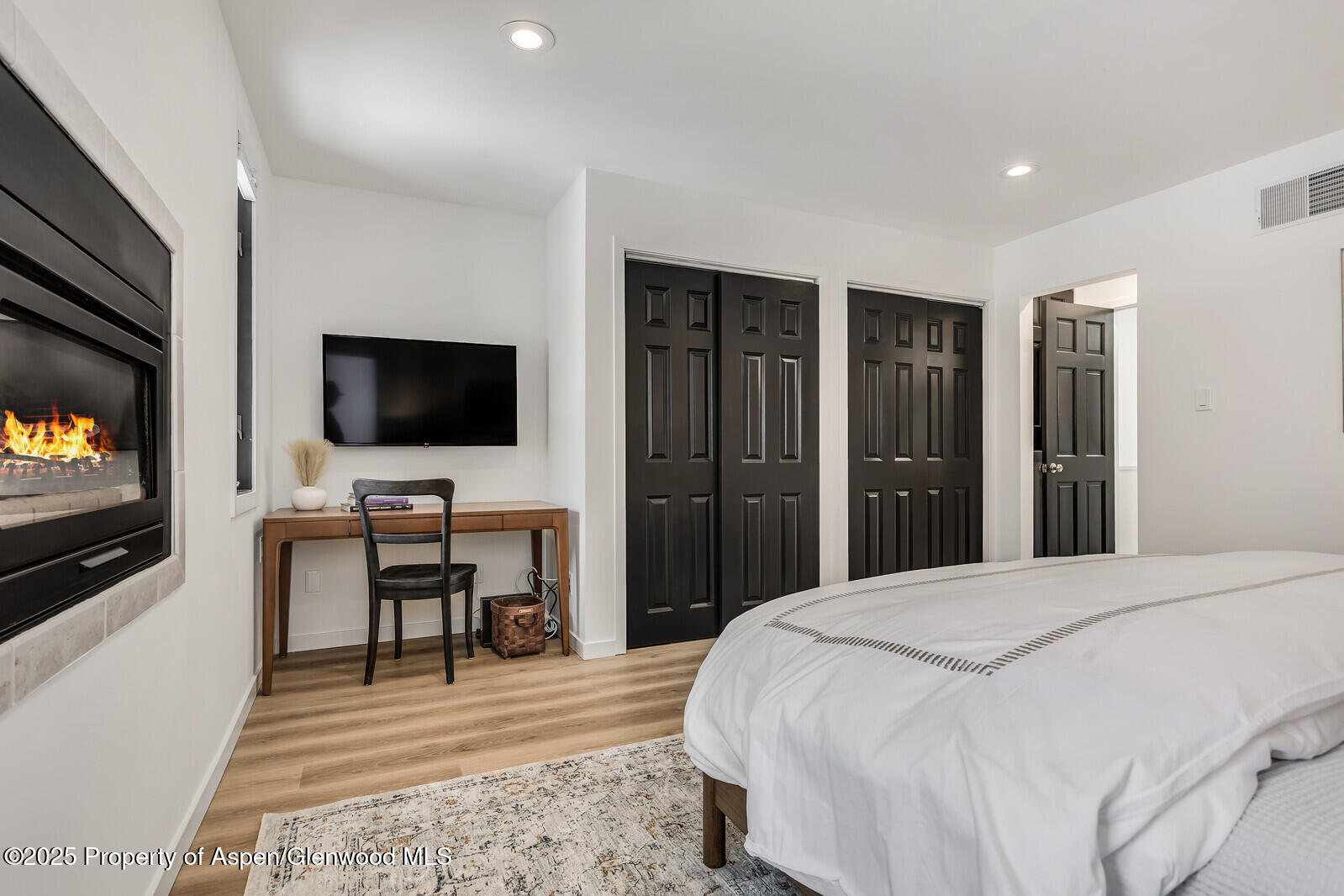 135 Carriage Way, Unit 5 Snowmass Village, CO 81615 - Photo 43 of 59 a bedroom with a bed and a flat screen tv