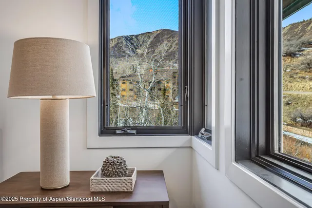 a view of a patio with table and chairs with wooden floor and fence