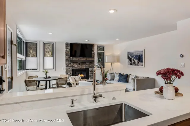a kitchen with stainless steel appliances a sink and a refrigerator