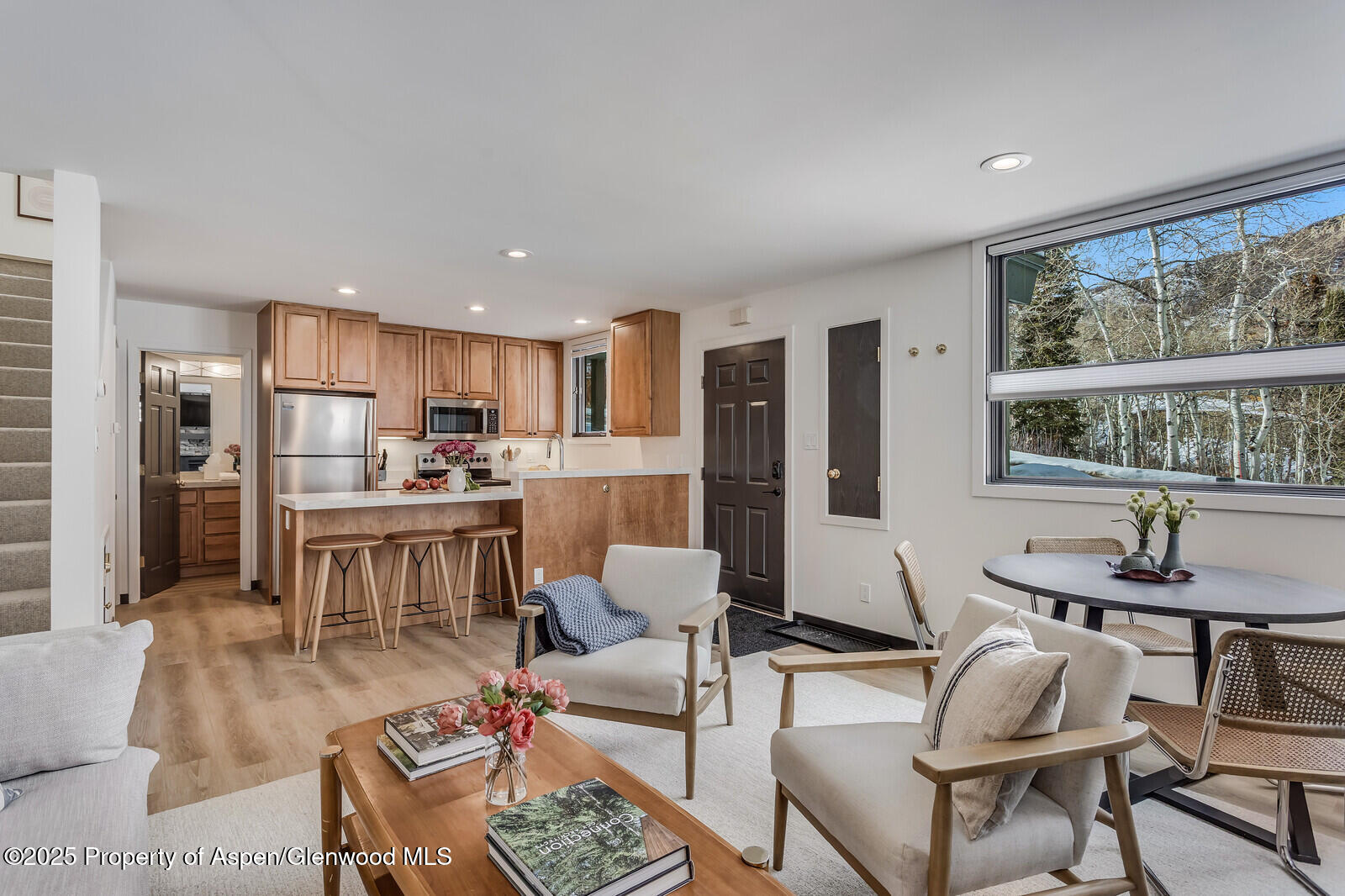 135 Carriage Way, Unit 5 Snowmass Village, CO 81615 - Photo 9 of 59 a living room with stainless steel appliances kitchen island granite countertop furniture and a large window