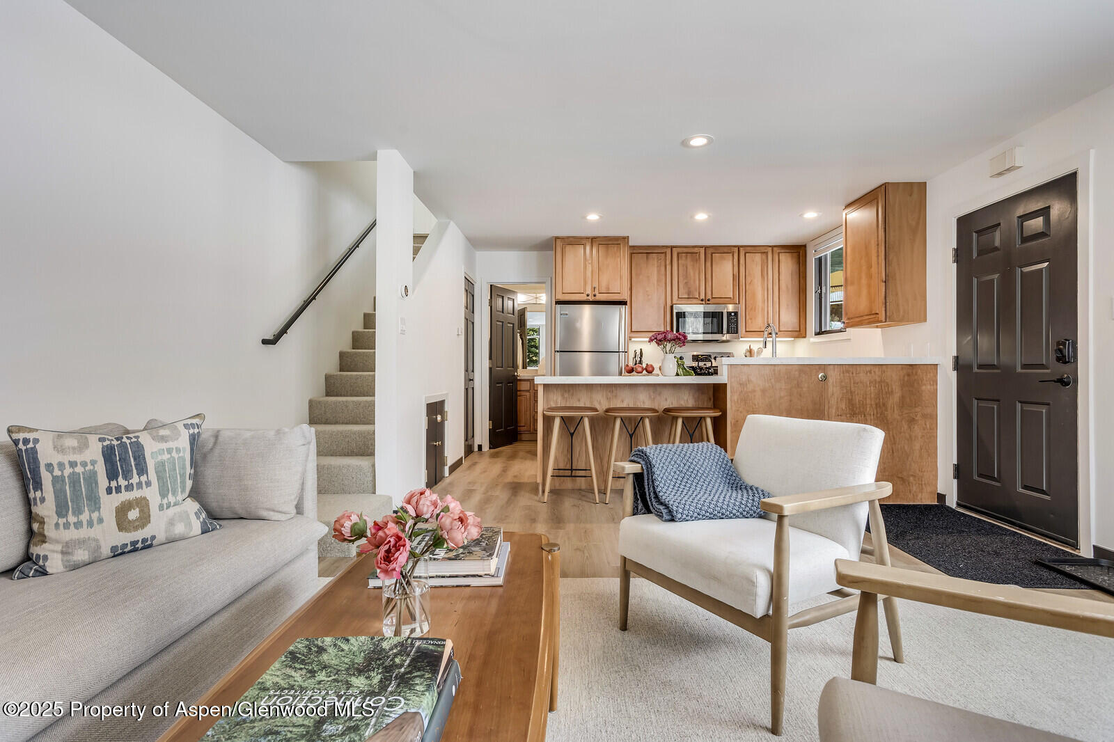 135 Carriage Way, Unit 5 Snowmass Village, CO 81615 - Photo 10 of 59 a living room with furniture and a dining table with kitchen view