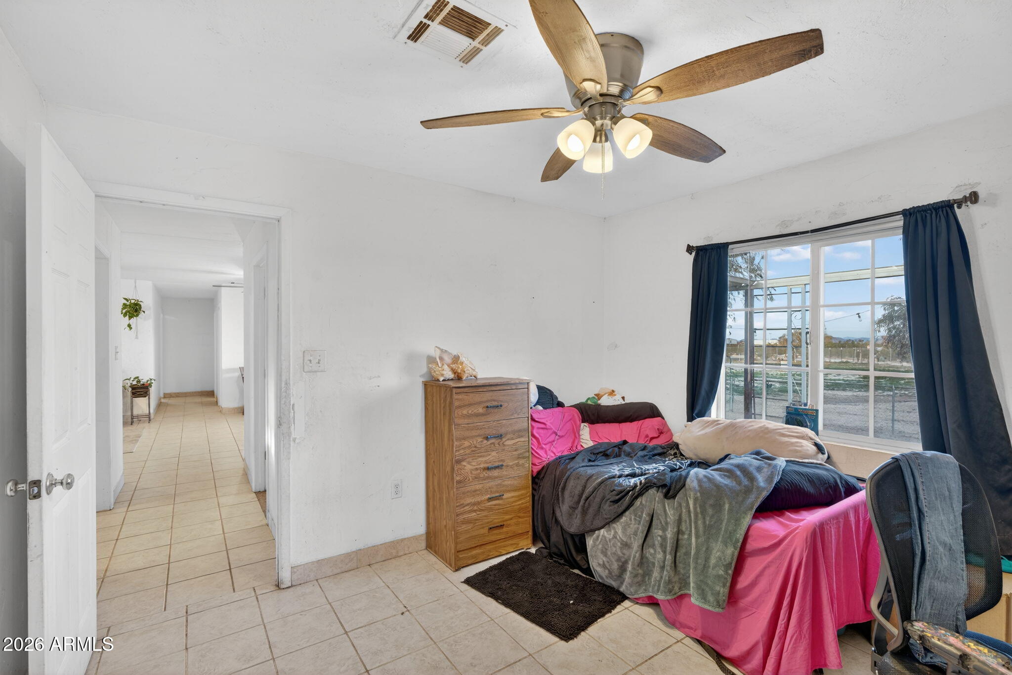 19500 West Bobcat Road Casa Grande, AZ 85122 - Photo 12 of 34 a view of a bedroom with a bed and a chandelier