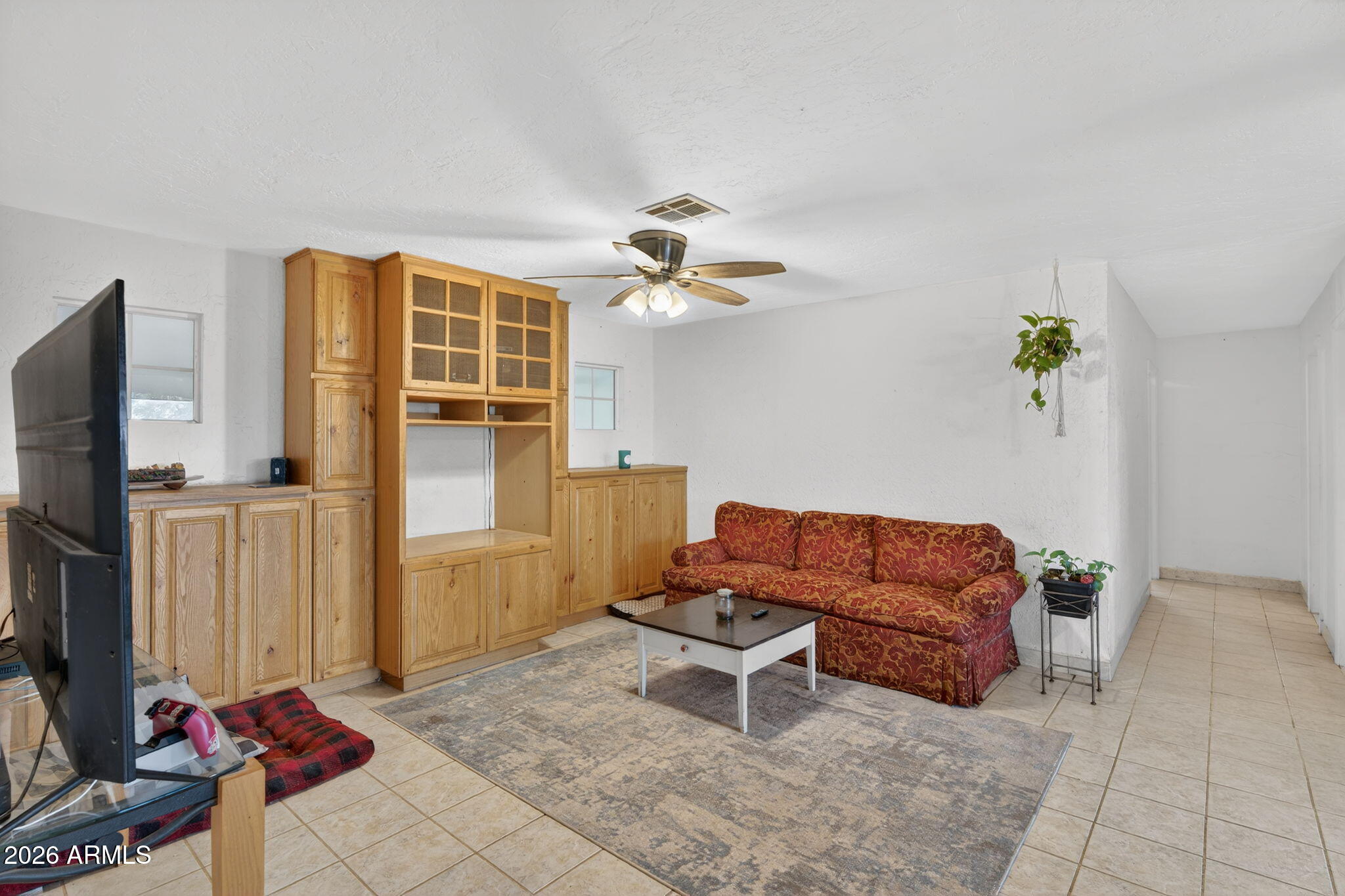 19500 West Bobcat Road Casa Grande, AZ 85122 - Photo 6 of 34 a living room with furniture a flat screen tv and a window