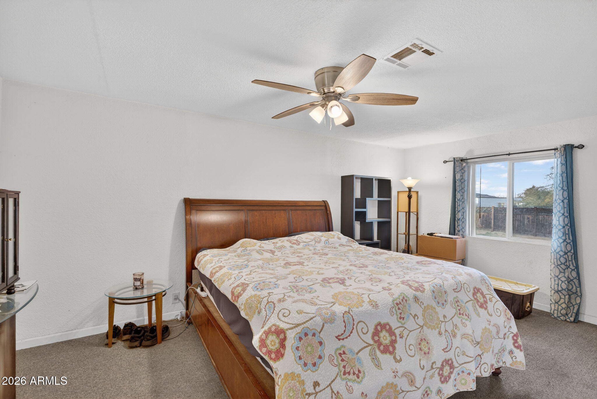 19500 West Bobcat Road Casa Grande, AZ 85122 - Photo 7 of 34 a bedroom with a large bed and a chandelier