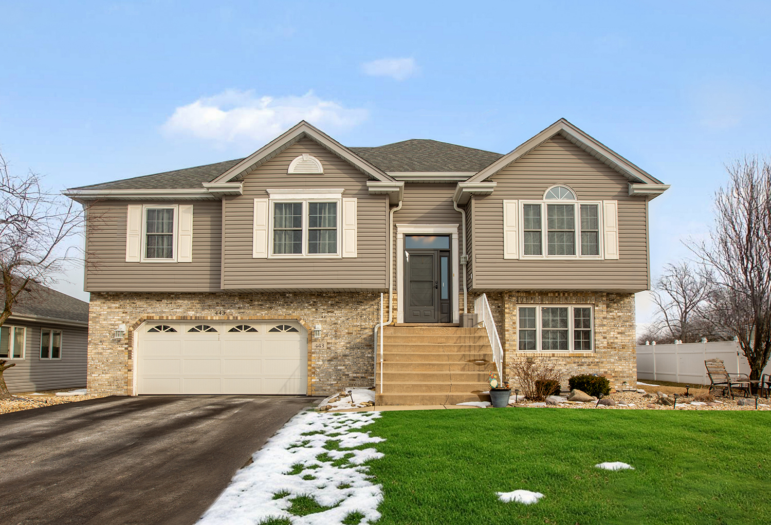 a front view of a house with a yard and garage