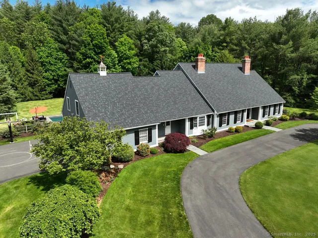 an aerial view of a house with a yard table and chairs
