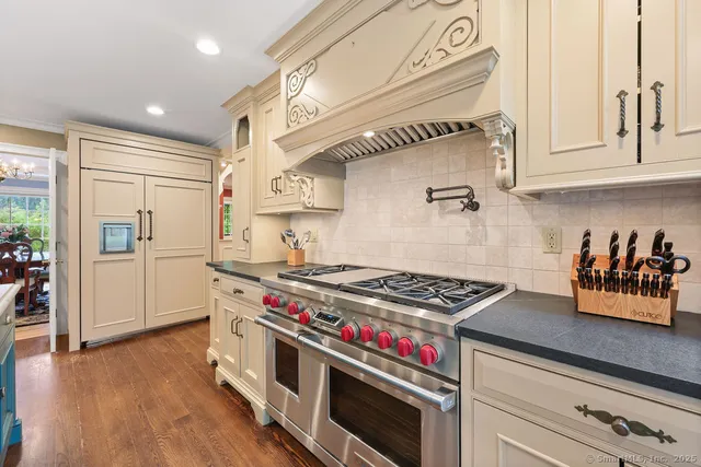 a kitchen with stainless steel appliances granite countertop a stove and a refrigerator