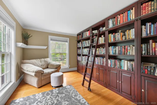 a living room with furniture and a book shelf