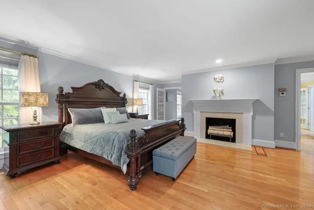 a spacious bedroom with a bed and a fireplace