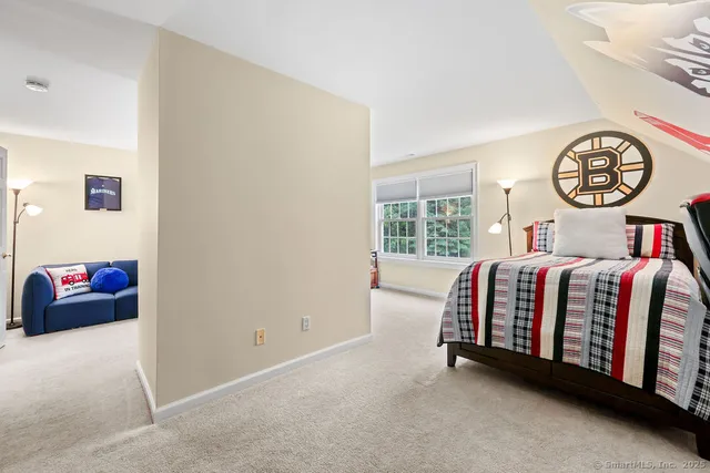 a bed sitting in a bedroom next to a window