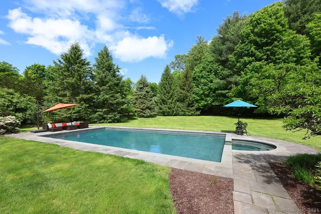 a view of a swimming pool and a yard