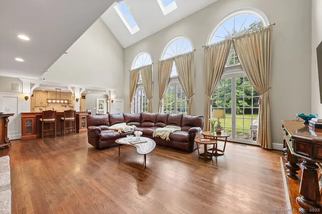a living room with fireplace furniture and a large window